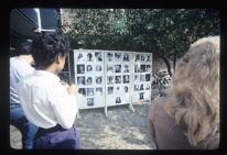 Students looking at a display of student portraits